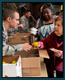 Service members passing out food to displaced residents.