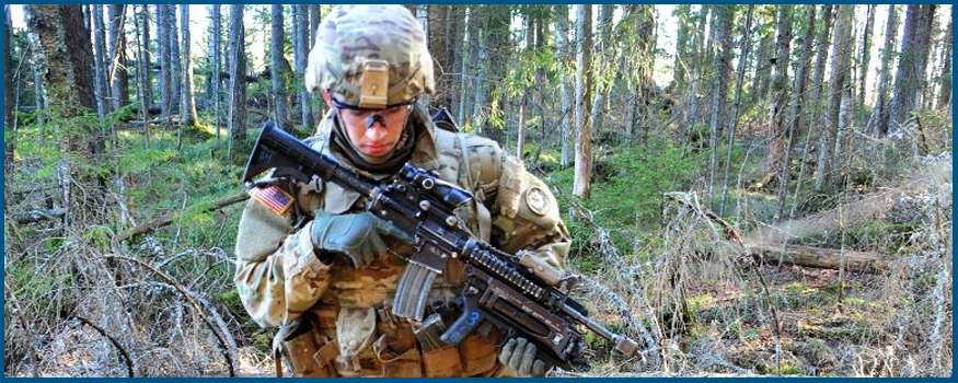Soldier walking through woods