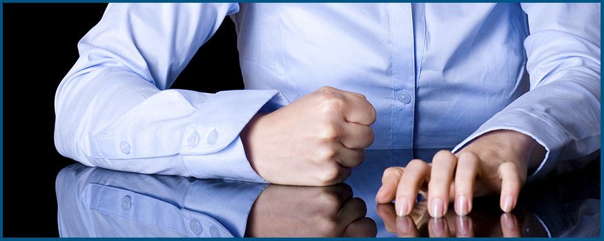 Woman making a fist on the table