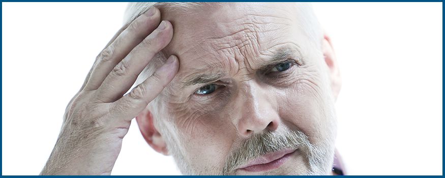 Man holding his head looking confused