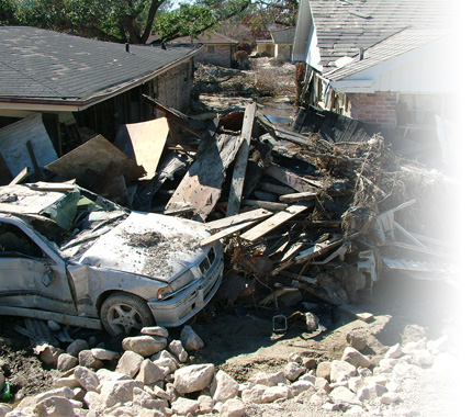 A destroyed home and car after a hurricane.