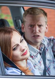 A man yelling at his spouse, she is looking away sad.