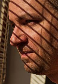 Man looking out window