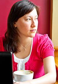 Woman working, distracted looking out window