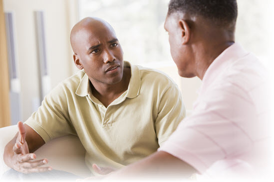 two men talking in an office setting