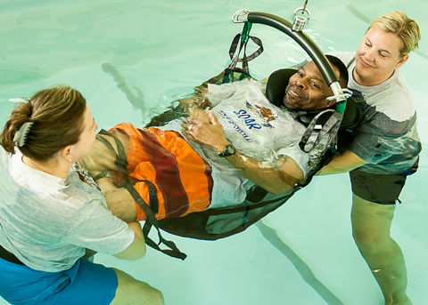 Veteran and two nurses in water therapy