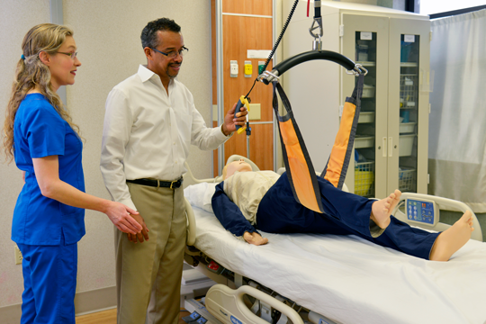 facility coordinator displaying how overhead lift works